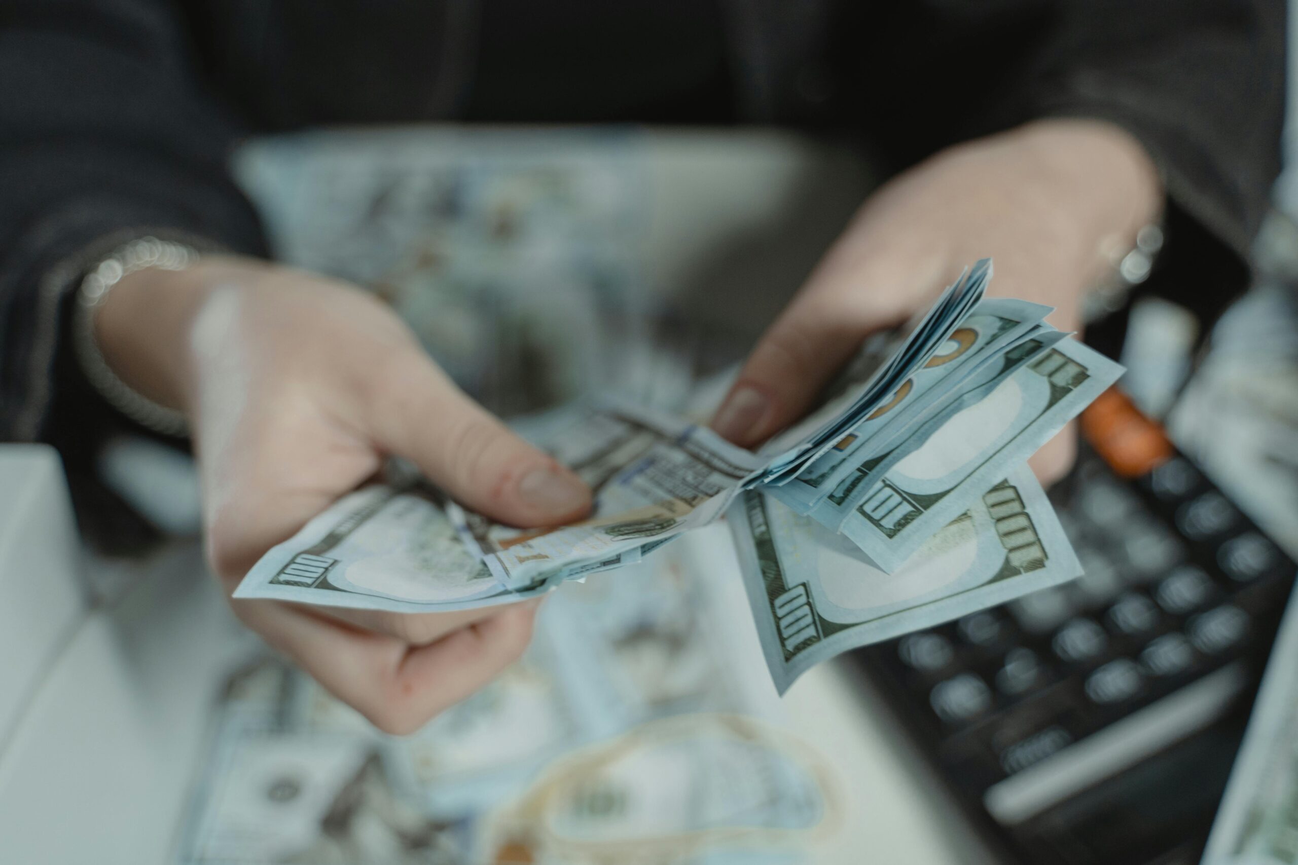 Entrepreneur managing cash symbolizing funding choices between a business line of credit vs loan.